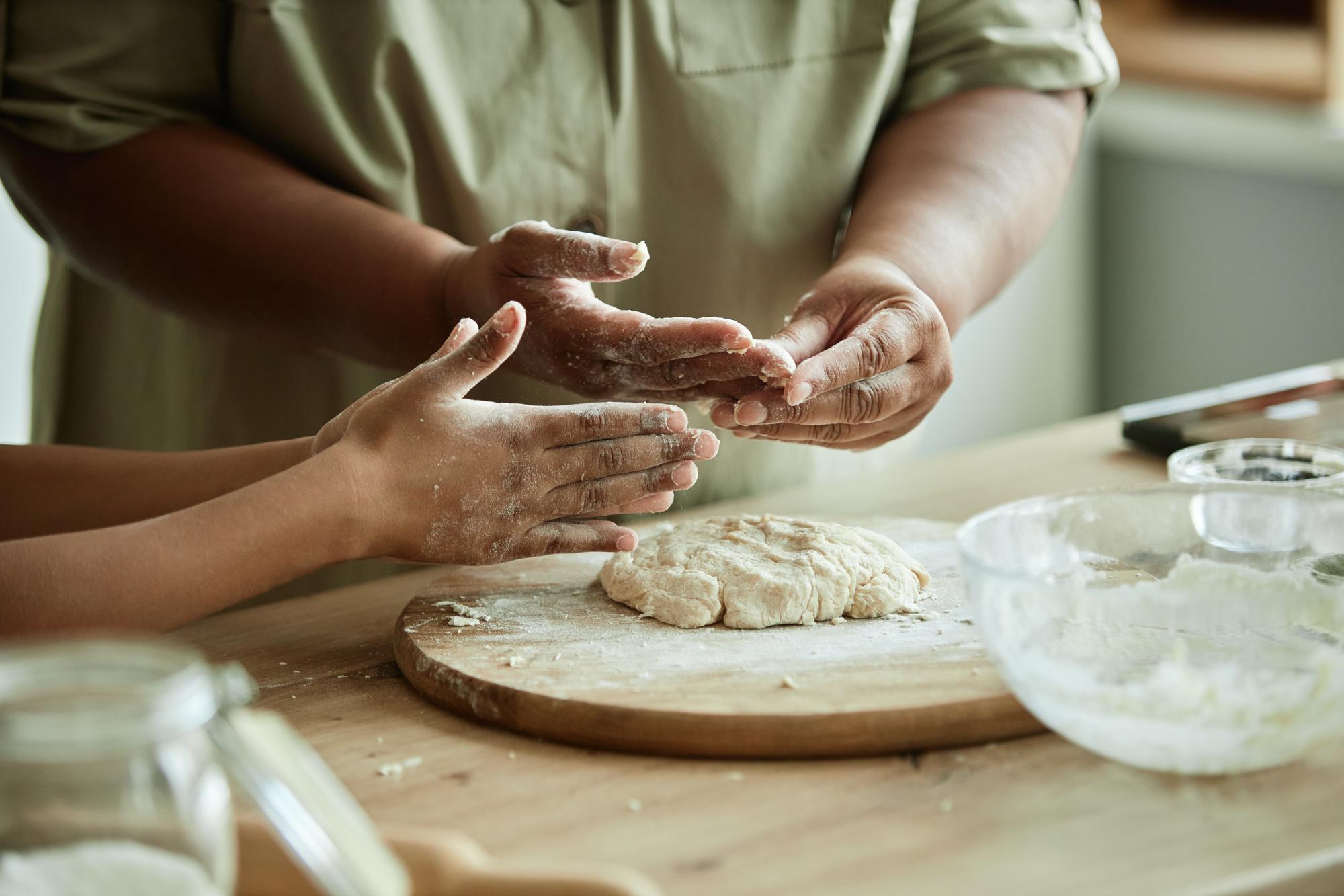 Close up of hands kneading dough